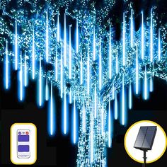 a solar powered tree with blue lights on it and an image of a cell phone next to it