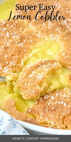 a close up of a cake in a pan with lemon cobbler on the side