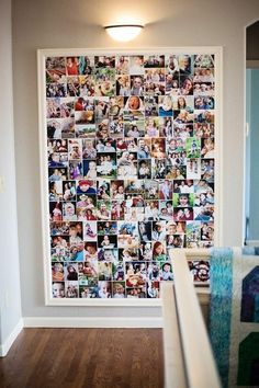 a wall with many pictures on it in a room next to a stair case and wooden floor