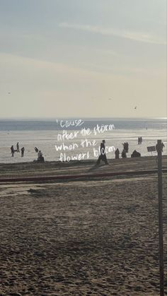 people are walking on the beach with their surfboards in hand and an ocean view behind them