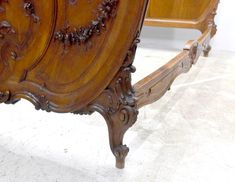 an ornate wooden bed frame with carved details