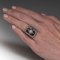 This fantastic circa Victorian era ring features a sterling silver and 18K yellow gold octagonal shaped gallery. The center of the gallery is topped with a diamond accented sterling silver star setting bordered with blue enamel. The star shaped setting is centered with one (1) bead set, old European cut diamond and is bordered with fourteen (15) old mine/rose cut diamonds bead set into the points of the star. The gallery is framed with thirty (30) old mine/singe cut diamonds bead set into sterli Yellow Gold Enamel Jewelry With Rose Cut Diamonds, Art Deco Enamel Ring As A Gift, Art Deco Enamel Ring As Gift, Collectible Hallmarked Enamel Ring In Fine Jewelry Style, Art Deco Enamel Ring Jewelry, Art Deco Enamel Jewelry Ring, Fine Jewelry Black Enamel Diamond Ring, Elegant Enamel Signet Ring For Anniversary, Polished Diamond Enamel Ring As Gift