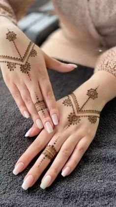 a woman with henna tattoos on her hands