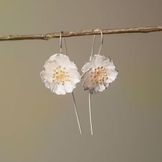 These Poppy Flower Drop Earrings, crafted from premium 925 silver, are an homage to the subtle power of nature's artistry. With petals that display a lifelike texture and a center delicately brushed with gold, they capture the wild and free essence of poppies in bloom. Lightweight and with a gentle sway, they offer a whisper of movement, a dash of sophistication to your daily wear or a statement piece for special occasions. Let these earrings be a symbol of resilience and beauty, mirroring the e Nature-inspired Earrings For Anniversary, Adjustable Sterling Silver Flower-shaped Earrings, Nature-inspired Sterling Silver Flower Earrings, Sterling Silver Birth Flower Drop Earrings, Sterling Silver Birth Flower Earrings For Anniversary, Nature-inspired Silver Flower Drop Earrings, Sterling Silver Birth Flower Earrings In Silver, Sterling Silver White Birth Flower Earrings, Silver Dangle Earrings With Birth Flower