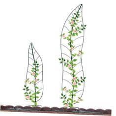 two metal sculptures with flowers and leaves on them