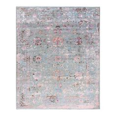 an area rug with various colors and patterns on the ground, including pinks, blue,