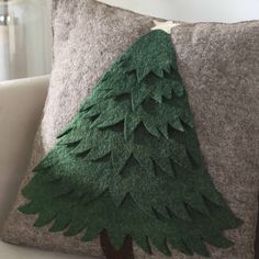 a green christmas tree on a gray pillow