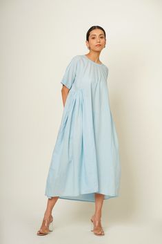 Introducing our City sky blue, Side-Back Gather Dress, meticulously crafted from organic cotton for a luxurious feel with eco-conscious flair. This size inclusive vacation essential boasts a refreshing hue and comfortable modest fit, complemented by thoughtful side and back gathers with convenient pockets and button closure at back. Whether wandering the beach or exploring new destinations, it ensures effortless style and comfort for your summer escapades. Specifications: Length: Front: 44.5" Ba Casual Organic Cotton Summer Dress, Blue Cotton Relaxed Fit Dress, Washed Blue Cotton Dress With Short Sleeves, Light Wash Cotton Dresses For Daywear, Light Wash Cotton Dress For Daywear, Light Blue Relaxed Fit Dress For Daywear, Washed Blue Cotton Dress For Daywear, Relaxed Fit Cotton Dress With Natural Dye, Blue Summer Dress With Natural Dye