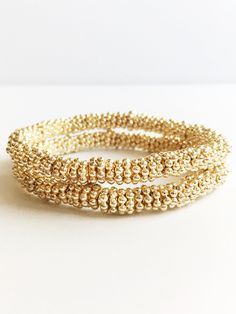 Medium Gold Stacking Bracelets ⟡ all items are designed and handcrafted in our studio ⟡14kt gold plated beads on stretch material. These stunning minimalist gold bracelets epitomize the essence of metallic sophistication. Their flexible design makes layering with other bracelets or a wristwatch a breeze. Elevate your fashion and indulge in a delightful new accessory that infuses a hint of opulence into any outfit.This listing is for one bracelet.OVERVIEW-7.25 inches long-14kt gold plated beadsLo Gold Wrap Bracelet With Tiny Beads As A Gift, Adjustable Gold Stretch Bracelet Hand-strung, Adjustable Hand-strung Gold Stretch Bracelet, Adjustable Gold Stretch Bracelet With Gold Beads, Elegant Wrap Bracelet With Tiny Beads For Gift, Elegant Wrap Bracelet With Tiny Beads As A Gift, Everyday Gold Beaded Stretch Bracelet, Dainty Gold Bracelets With Gold Beads, Handmade Stretch Bracelet With Gold Round Beads