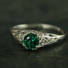 "Emerald Ring Cinderella Lab Grown Emerald May Birthstone Ring Silver Engagement Ring Promise Ring Filigree Emerald Ring Vintage Style Ring \"If you keep on believing, the dream that you wish will come true\" Cinderella sparks memories of glass slippers, fairy god mothers, and dancing until midnight. This is her ring...dainty, intricate and as stunning as can be! A detailed filigree setting securely holds a 5mm genuine Lab Grown Chatham Created Emerald. It is surrounded by intricate vining filig Heirloom Style Solitaire Rings For May Birthstone, Elegant Engraved Open Ring With Gemstone, Elegant Engraved Gemstone Open Ring, Heirloom Solitaire Emerald Ring, Emerald Ring With Intricate Design, Classic Emerald Crystal Ring, Vintage Promise Rings With Intricate Design, Elegant Emerald Crystal Promise Ring, Victorian Birthstone Promise Ring Jewelry