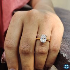 a woman's hand with a diamond ring on it