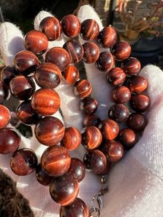 A vintage Chinese export red Tiger's Eye large bead necklace with lobster claw closure.  The necklace is made of 48 natural red Tiger's Eye gemstone beads. The colour of the beads are darker than the normal Tiger's Eye and the beads have reddish-brown bands. This type of Tiger's Eye is sometimes also referred to as Ox's Eye or Bull's Eye. The diameter of each bead is about 1.4cm. As all beads are made from natural tiger's eye gemstones, they are not identical and some of them have imperfections such as inclusions.  The necklace is strung into a single strand of 60cm long and fitted with copper lobster clasp. The original clasp is worn out and not tight enough to hold the weight of this necklace (120 grams), so I replaced it with a new one. However I have kept the original clasp in a small Types Of Tigers, Large Bead Necklace, Red Tigers Eye, Chinese Export, Tigers Eye Gemstone, Tiger Eye Beads, Reddish Brown, Tiger's Eye, Natural Red