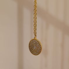 Our Crystal Medallion Necklace features a round charm with Cubic Zirconia crystals. This minimalist necklace is inspired by the beautiful night sky filled with stars and will look great layered or worn alone. This necklace is perfect for wearing on an evening out or to glam up your day time casual wear. We make our jewellery in small batches to reduce wastage. Our jewellery is designed with the modern Woman in mind, elegant, unique pieces with a classic touch. Our jewellery is great for gifting, Diamond Charm Necklace With Adjustable Chain, Gold Circular Diamond Necklace As Gift, Gold Diamond Necklace With Adjustable Chain, Delicate Coin Pendant Necklace, Elegant Diamond Necklace With Coin Pendant, Elegant Moon Charm Necklace, Minimalist Jewelry With Sparkling Stones, Elegant Circle Coin Necklace With Adjustable Chain, Elegant Round Coin Necklace With Clavicle Chain