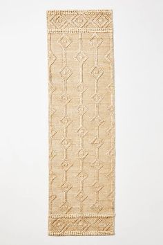 a beige rug with an intricate design on the front and back side, against a white background