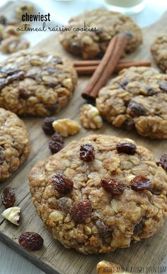 oatmeal raisin cookies on a wooden board with cinnamon sticks and cloves