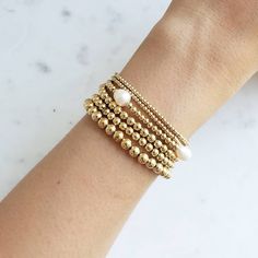 Gold Bead Bracelet, Beaded Bracelet, Gold Bracelet Stack, Stacking Bracelet 2mm 3mm 4mm, Dainty Bracelet Classic gold bead bracelet is a perfect addition to a dainty stack this spring/summer season. The beads are strung on a premium stretch cord. SOLD BY ONE BRACELET ITEMS DETAILS: Water Resistant -Nickel-free - Allergy-free - - High-Quality 18K gold plated brass beads made to last - round bead size: 2mm, 3mm, 4mm, 5mm -Freshwater pearls ( due they are natural pearls may vary the size and shape) Stackable Adjustable Pearl Bracelet With Round Beads, Stackable Pearl Bracelet With Round Beads As Gift, Stackable Pearl Bead Bracelet As A Gift, Stackable Round Bead Pearl Bracelet As Gift, Gift Stackable Pearl Bracelet With Round Beads, Stackable Round Bead Pearl Bracelet For Everyday, Adjustable Stackable Pearl Bracelet With Round Beads, Stackable Pearl Bracelet With Round Beads, Minimalist Stackable Bracelets With Round Beads