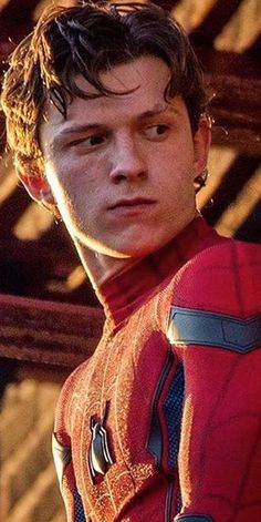 a young man in a spider - man costume