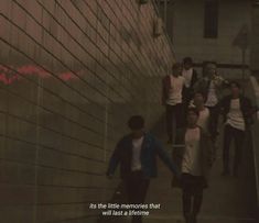 people are walking up and down the stairs in front of a wall that says, its the little memories that will last come