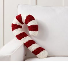 a red and white striped candy cane on a white couch