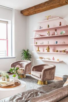 a living room filled with furniture and pink shelves