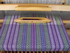 a close up of a weaving machine with yarn on it