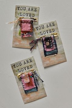 three small cards with words on them that say you are loved