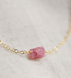 This handcrafted necklace features a raw Pink Tourmaline crystal, known for its ability to heal matters of the heart and inspire feelings of love and happiness. It's also believed to bring peace during times of transformation. Plus, Tourmaline is October's birthstone! Choose from sterling silver or 14k gold fill chains. Average Stone Size: 7x5mm (.27x.19") Modeled Length: 15 Inches Match with our Raw Pink Tourmaline ring here. Pink Tourmaline Jewelry For Healing, Dainty Tourmaline Necklace For Gift, Healing Pink Tourmaline Jewelry, Spiritual Raw Stone Necklace For Gift, Adjustable Mineral Crystal Necklace With Raw Stone, Dainty Raw Stone Jewelry For Healing, Healing Tourmaline Gemstone Necklace, Spiritual Tourmaline Jewelry Gift, Holistic Necklace With Raw Stone For Gift