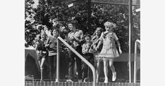 an old black and white photo of children on a playground