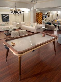 a living room filled with furniture and a large table in the middle of the floor