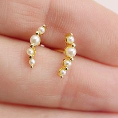 Add a sweet touch to your ear stack with our Pearl Climber Earrings. Choose from gold or silver to effortlessly achieve a delicate look, perfect for everyday wear. Layer them with our pearl huggies for a stylish and versatile option. See the matching pearl huggies here: https://etsy.me/4fsrWY6 DETAILS: - stud back - measures 12mm long - available in gold or silver Materials: - sterling silver or 14kt gold plated over sterling silver - nickel free - synthetic pearls Packaging + Delivery: All items come packaged in a cute Amanda Deer Jewelry box and are sent in a protective bubble mailer. If ordering multiple pieces, please let us know if you'd like separate boxes for each one. If not, we'll include them in one box for you. See all of our listings here: http://www.amandadeer.etsy.com XOXO Th Dainty Tiny Ear Climbers For Everyday, Dainty Ear Climbers For Everyday, Delicate Yellow Gold Ear Climbers For Everyday, Dainty 14k Gold Ear Climbers, Gold Dainty Ear Cuff For Anniversary, Dainty Gold Ear Cuff For Anniversary, Elegant Everyday Ear Cuff, Dainty Yellow Gold Ear Climbers Gift, Dainty Sterling Silver Ear Climbers