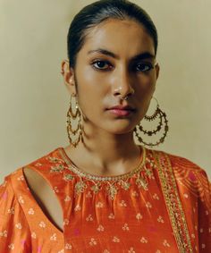 The rust printed, hand-embroidered kurta in dupion silk paired with printed flared pants and a tasseled dupatta sounds like a striking ensemble. The hand embroidery adds intricate detailing to the kurta, while the printed pants and dupatta complement the overall look with their coordinated design. Orange Palazzo Set With Zari Work And Straight Kurta, Festive Slub Silk Palazzo Set With Gota Work, Orange Chanderi Palazzo Set With Gota Work, Navratri Tussar Silk Sharara With Dabka Work, Festive Orange Palazzo Set With Straight Kurta, Orange Anarkali Palazzo Set With Gota Work, Anarkali Tussar Silk Palazzo Set, Bollywood Style Orange Palazzo Set With Straight Kurta, Orange Chanderi Palazzo Set For Festivals