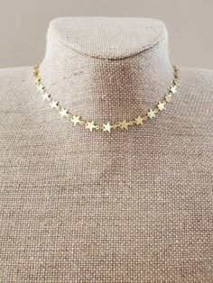 Gold stars adorn this choker necklace. Approximately 13" with a 2" extender. Hoco Inspo, Star Choker, Cross Earrings Studs, Cross Ring, Gold Dipped, Cross Pendant Necklace, Gold Star, Gold Stars, Cross Pendant