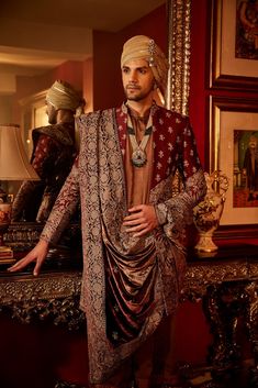 Balhan-E-Shaan Elevate your look with the timeless sophistication of Angad Creations' Men's Embroidered Sherwani. Meticulously crafted from exquisite Art Raw Silk, this ensemble is not just clothing; it's a tribute to heritage, emanating a captivating ethnic allure. Perfect for weddings, this attire embodies tradition and refinement in every detail, ensuring you exude an aura of distinguished elegance. Product Details - Condition: Brand New (made to order) - Style: Sherwani - Fabric of Sherwani: Bollywood Style Sherwani With Dabka In Traditional Fit, Festive Bandhgala With Zari Work In Traditional Fit, Festive Bandhgala With Zari Work, Traditional Fit Bandhgala For Eid, Eid Traditional Bandhgala, Traditional Wear With Resham Embroidery And Traditional Drape, Traditional Fit Bollywood Bandhgala For Eid, Traditional Fit Sherwani With Zari Work For Eid, Eid Sherwani With Zari Work And Traditional Fit