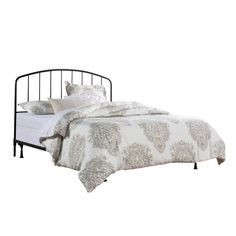 an iron bed frame with pillows and blankets on top of it, against a white background