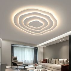 a modern living room with white furniture and lights on the ceiling is lit by recessed lighting