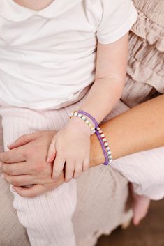 A little fun + a little fancy. Whimsy is a blend of sophisticated creamy pearls + tiny rainbow seed beads making it 100% dreamy to add into your wardrobe. The perfect accessory for every Mom + her mini! Made with the highest quality materials, this bracelet will look beautiful for years to come. Durable enough for play, precious enough to keep forever. Materials: 14k gold filled or sterling silver components. Nickel free. To learn more about our materials and what makes gold filled unique read here. Features: Each bracelet has a ½” extender chain to allow it to grow with your child. Guarantee: 100% satisfaction guaranteed. If you don’t love it, contact us to arrange a return/exchange. Read more about our quality guarantee here. PLEASE WATCH TEETHING BABIES CAREFULLY AS SMALL COMPONENTS CAN Adjustable Pearl Beaded Bracelets With Spacer Beads, Adjustable Beads With Pearl Charm, White Bohemian Pearl Bracelet With Pearl Charm, White Bohemian Pearl Bracelet With Charm, Adjustable Beaded Pearl Bracelets With Pearl Charm, Adjustable Beaded Pearl Bracelet With Pearl Charm, Purple Beaded Pearl Bracelet, White Pearl Bohemian Beaded Bracelets, Bohemian White Pearl Beaded Bracelets