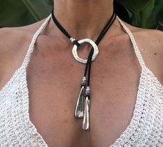 Crafted with meticulous care and a touch of bohemian charm, this handmade leather lariat necklace is the epitome of elegance. Perfect for beach weddings or adding a hint of sophistication to everyday wear, this pendant necklace exudes a unique sense of style. The Y-shaped design adds a modern twist to the classic lariat, making it a versatile piece that can effortlessly transition from day to night. The supple leather cord of this boho necklace enhances its natural appeal, while the pendant provides a focal point that captures attention. Whether you're looking to elevate a casual outfit or complement a formal dress, this leather necklace is sure to make a statement.  Embrace your inner free spirit with this bohemian-inspired accessory that embodies both simplicity and sophistication. Each Bohemian Silver Necklace With Sliding Knot, Bohemian Lariat Necklace With Sliding Knot, Adjustable Lariat Necklace For Festival, Festival Lariat Choker Necklace With Adjustable Length, Festival Adjustable Lariat Choker Necklace, Adjustable Silver Artisan Lariat Necklace, Festival Long Lariat Necklace With Adjustable Length, Bohemian Lariat Necklace With Adjustable Cord, Adjustable Lariat Necklace For Festivals