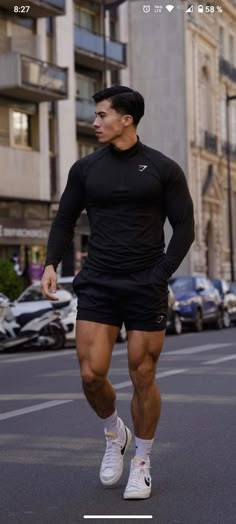 a man is running down the street in shorts