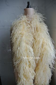 a mannequin wearing a white fur vest