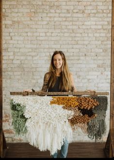 a woman standing in front of a weaving machine