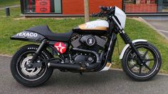 a black and white motorcycle parked in front of a building