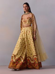 Unveil your elegance with this beautifully crafted threadwork and hand-embroidered corset, adorned with intricate sequins. Styled with a flared sharara and a coordinated net cape, it accentuates the stylized blouse back beautifully. This outfit is perfect for weddings or glamorous parties, ensuring you shine at every event. Yellow Sharara, Glamorous Party, Modern Woman, Hand Embroidered, Silk, Festival, Couture, Luxury Fashion, Celebrities