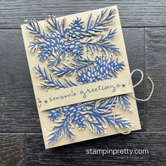 a handmade card with blue snowflakes and the words seasons greeting on it