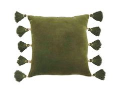 a green pillow with tassels on it