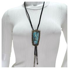 Introducing the 1960s Native American Silver Turquoise Bolo Necklace, a captivating piece that showcases the rich tradition and craftsmanship of Native American artisans. This stunning bolo-style necklace features a beautifully vibrant rectangular turquoise stone set in pure silver, creating a bold and eye-catching statement. The black chord offers a classic bolo design, providing a touch of Western charm and versatile styling. The turquoise stone, with its striking color and unique patterns, is Bolo Necklace, Bolo Ties, Hermes Handbags, Cartier Ring, Style Necklace, The 1960s, Native American Jewelry, Belleza Natural, Silver Turquoise