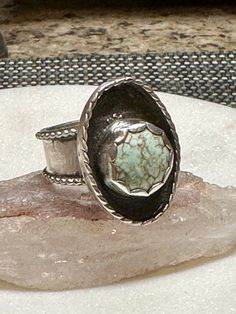 This rare stone is set an asymmetrical sterling silver position and is a size 6 3/4. It can be sized up to 3/4 of a size. Vintage Sterling Silver Turquoise Ring With Large Stone, Artisan Turquoise Ring With Large Stone Collectible, Artisan Turquoise Ring With Large Stone, Southwestern Silver Turquoise Ring With Natural Stones, Untreated Silver Turquoise Ring, Antique Style Untreated Silver Turquoise Ring, Antique Untreated Turquoise Ring In Silver, Artisan Silver Turquoise Ring Untreated, Antique Style Silver Turquoise Ring