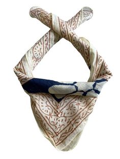 a white and blue bandana with an intricate design on the front, hanging from a hook