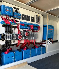 an electrical panel with many different types of wires and tools attached to the wall in front of it