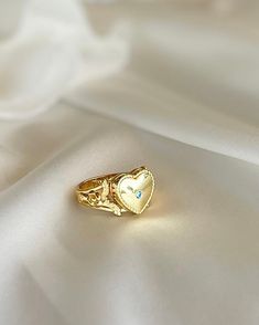 This Heart Locket Ring is crafted from gold plated silver for a luxurious feel and timeless look. Its elegant design is perfect for the special occasions that call for you to make a powerful, romantic statement. Wear it to express love, adoration, or devotion. Elegant Flower Open Ring For Valentine's Day, Elegant Open Flower Ring For Valentine's Day, Dainty Gold Signet Ring For Promise, Vintage Promise Jewelry For Valentine's Day, Valentine's Day Heirloom Ring Jewelry, Heirloom Style Valentine's Day Jewelry Ring, Valentine's Day Heirloom Ring, Dainty Gold Plated Signet Ring For Wedding, 14k Gold Heart-shaped Proposal Jewelry