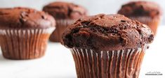 chocolate muffins sitting on top of a white counter